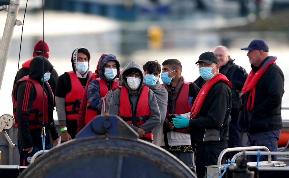 A group of people thought to be migrants are brought in to Dover, Kent