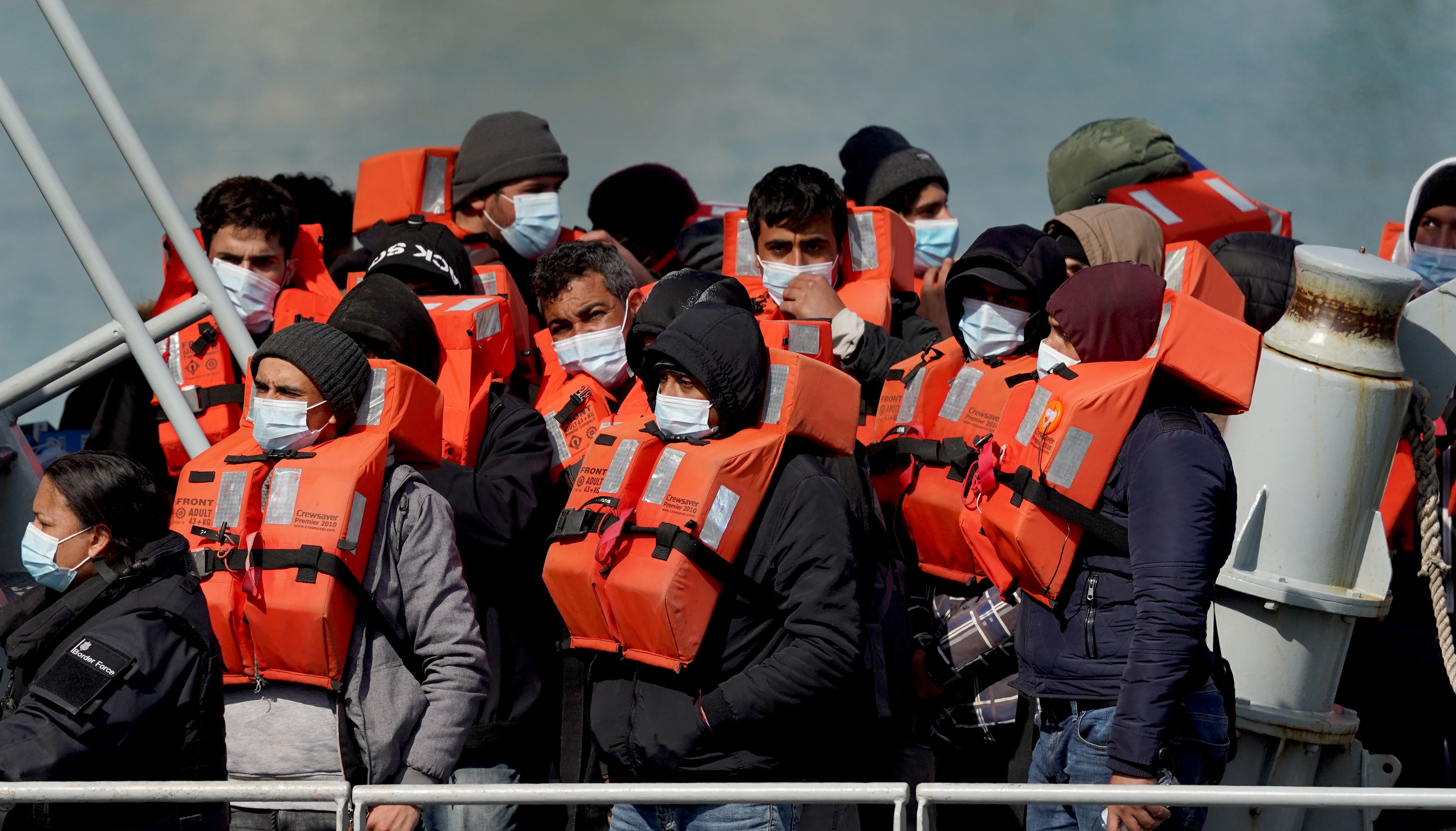 A group of people thought to be migrants are brought in to Dover, Kent
