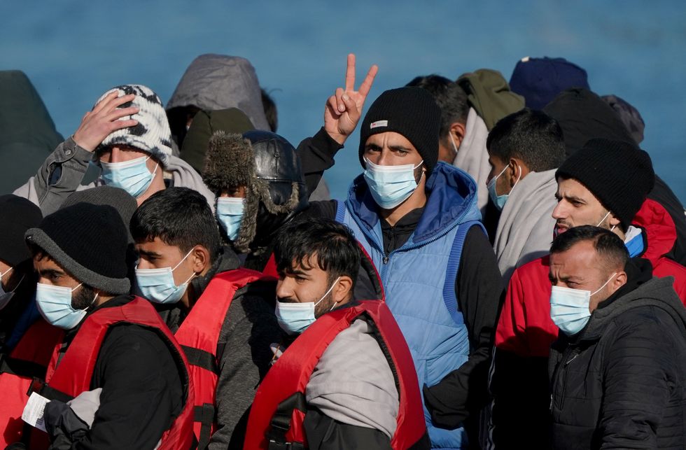 A group of people thought to be migrants are brought in to Dover, Kent.