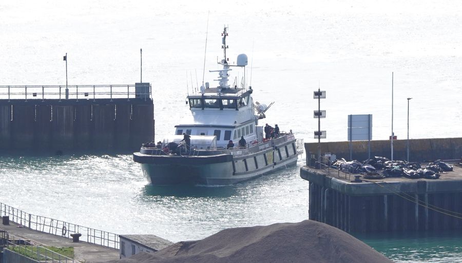 A group of people thought to be migrants are brought in to Dover, Kent.