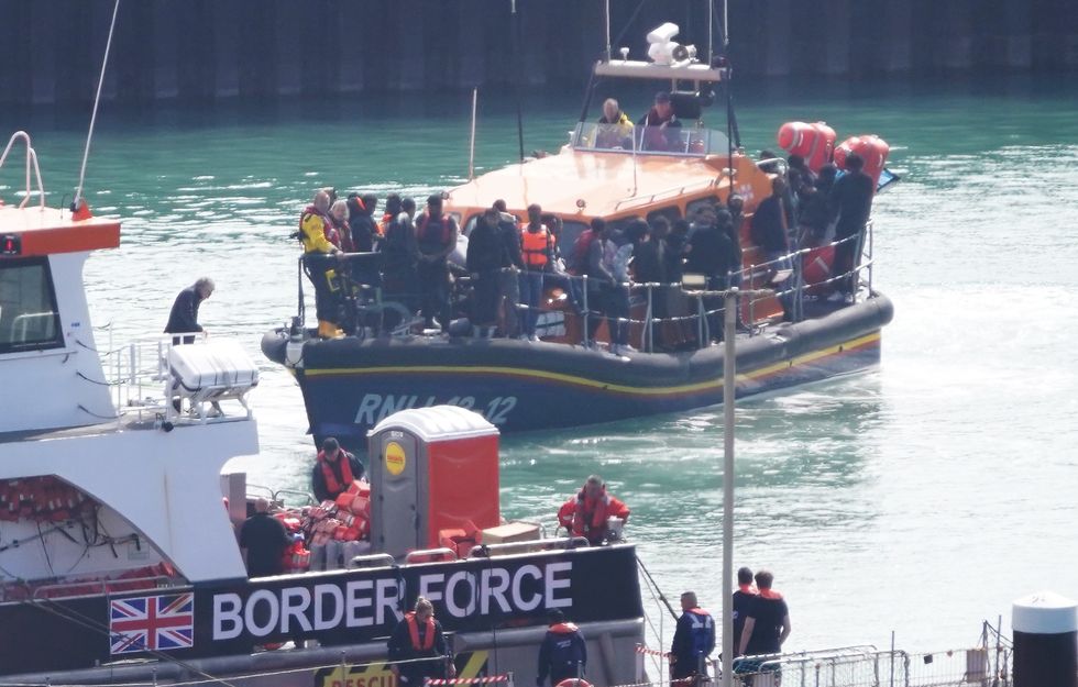 A group of people thought to be migrants are brought in to Dover, Kent,
