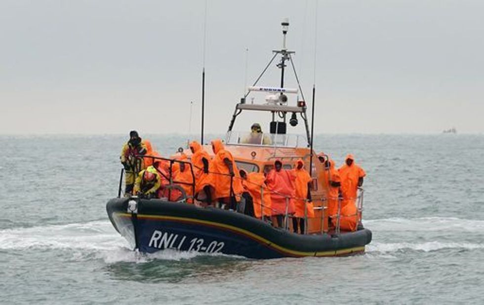 A group of people thought to be migrants are brought in to Dungeness, Kent, after being rescued by the RNLI following a small boat incident in the Channel. Picture date: Friday December 9, 2022.
