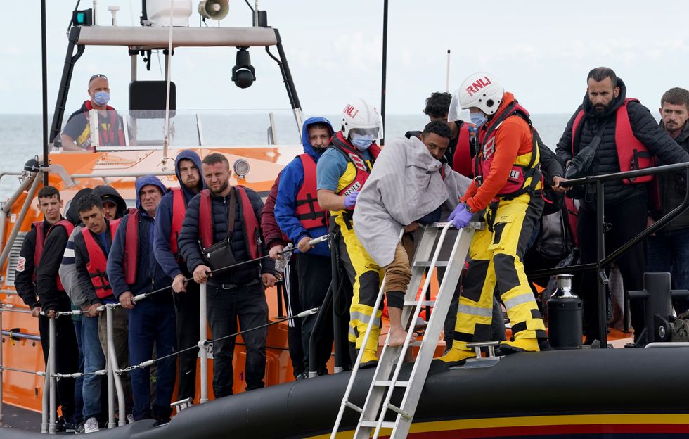 A group of people thought to be migrants are brought in to Dungeness, Kent, after being rescued by the RNLI following a small boat incident in the Channel. Picture date: Thursday September 15, 2022.