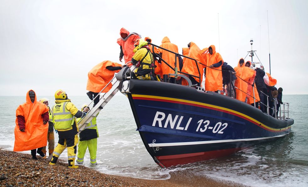 A group of people thought to be migrants are brought in to Dungeness, Kent, after being rescued by the RNLI following a small boat incident in the Channel