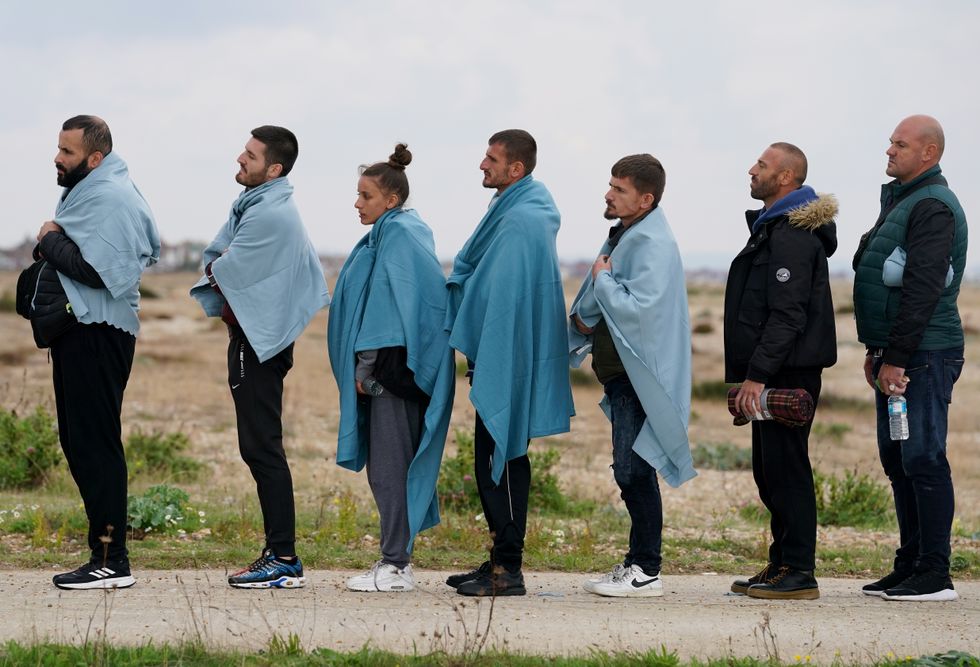 A group of people thought to be migrants are brought in to Dungeness, Kent, by Border Force officers, after being rescued by the RNLI following a small boat incident in the Channel. Picture date: Thursday September 15, 2022.