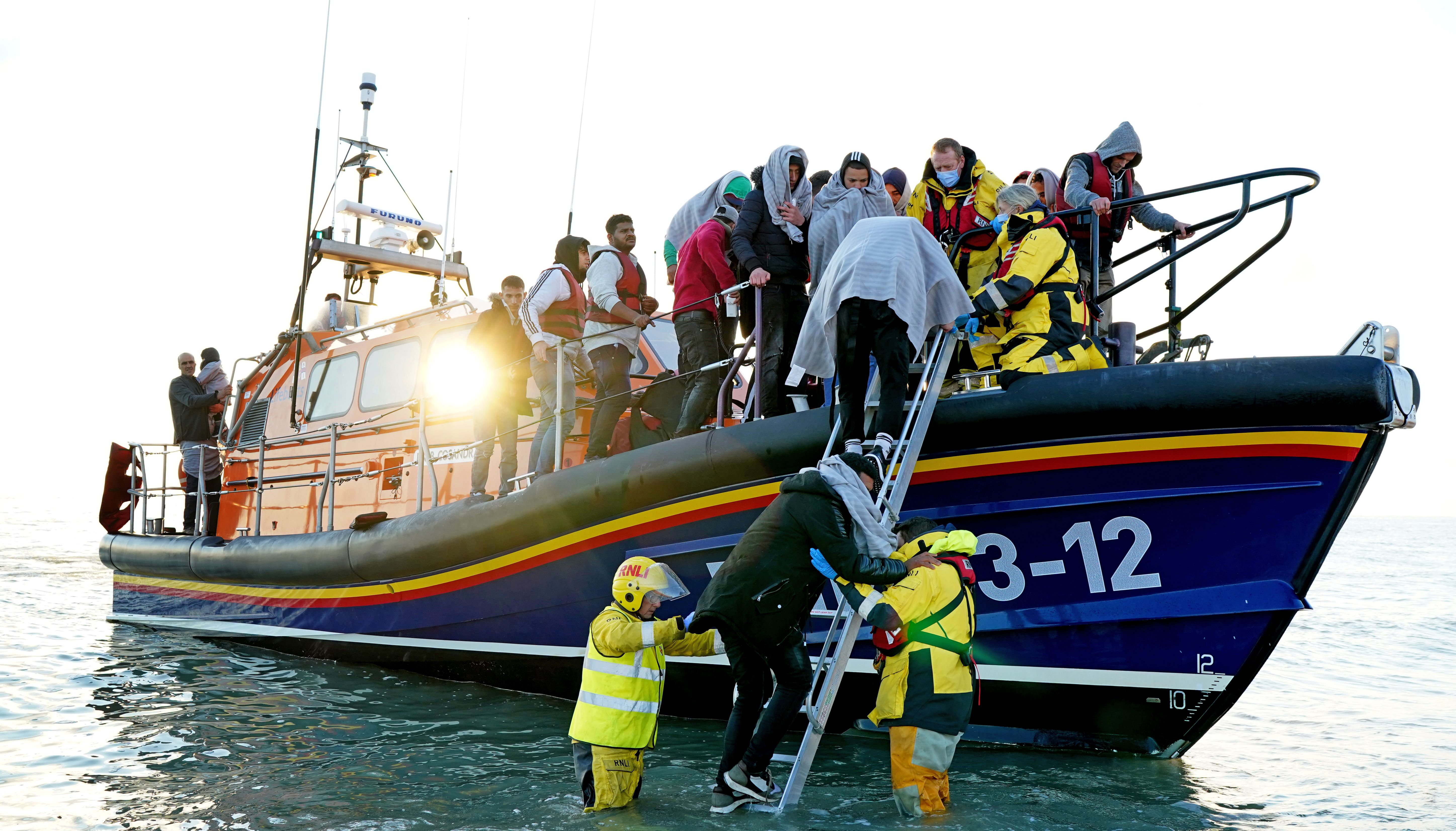 A group of people thought to be migrants are brought in to Dungeness, Kent, by the RNLI following a small boat incident in the Channel. Picture date: Wednesday September 21, 2022.