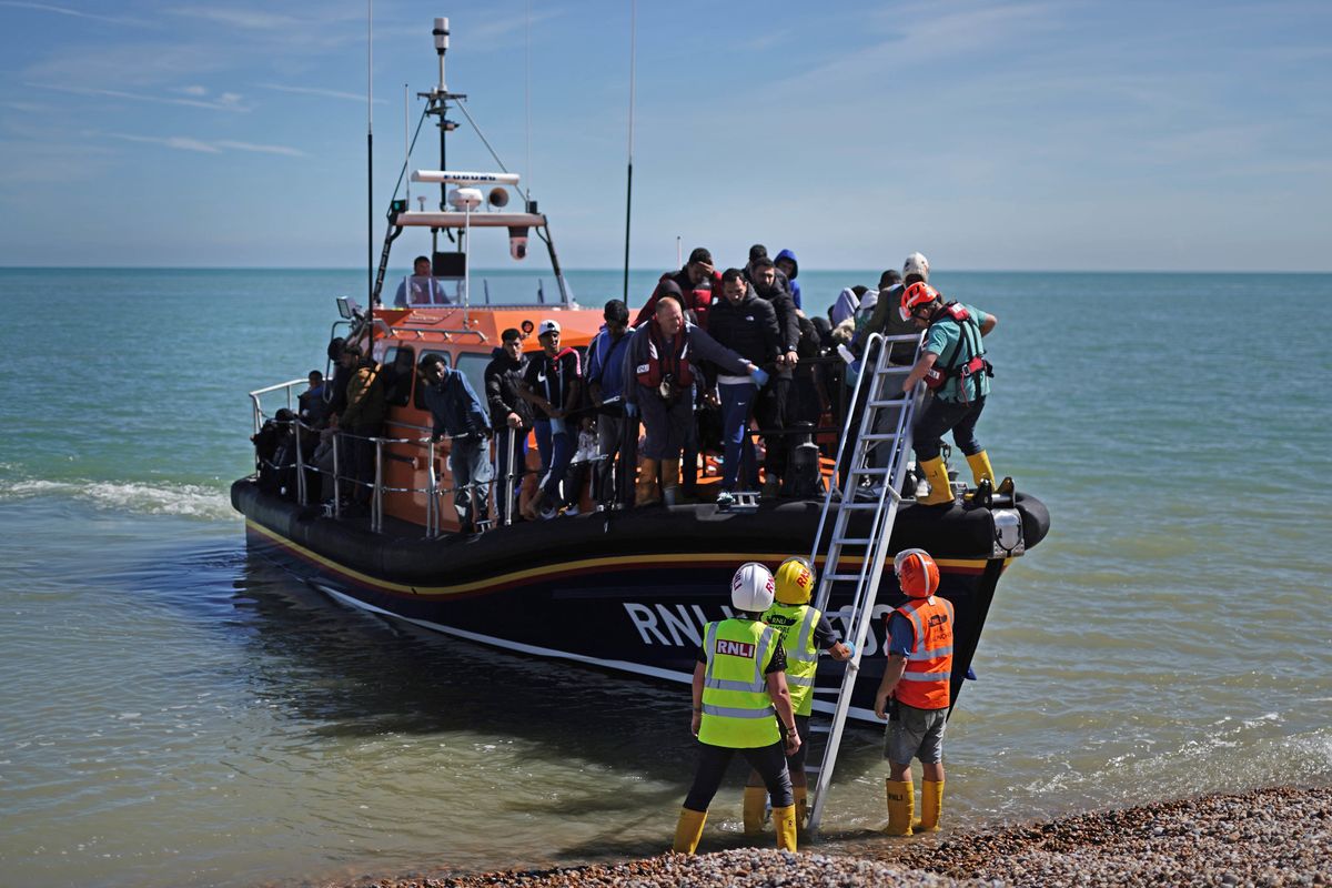A group of people thought to be migrants are brought in to Dungeness, Kent, onboard an RNLI Dungeness Lifeboat