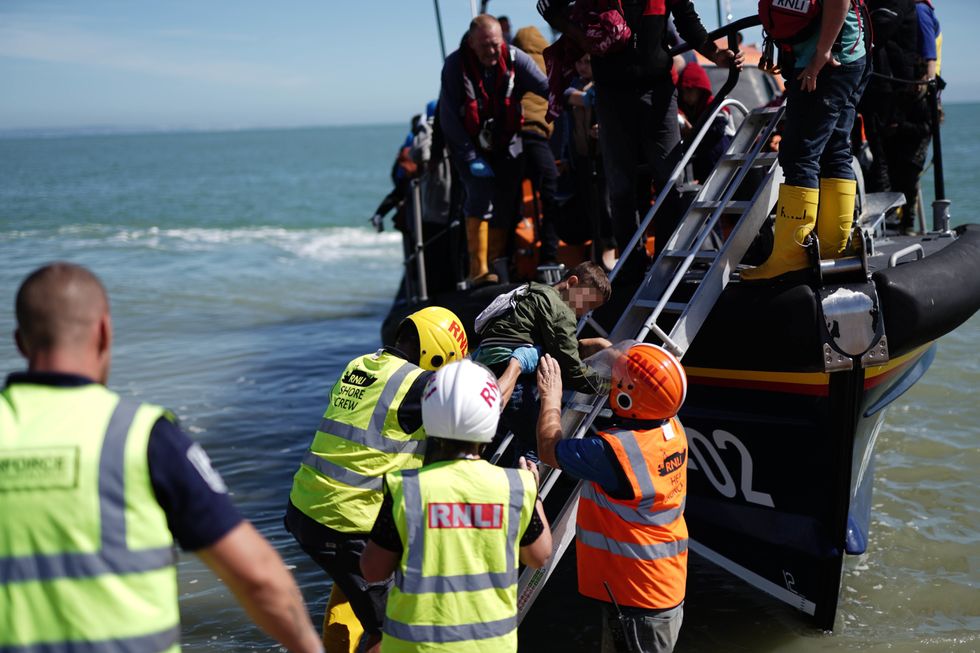 A group of people thought to be migrants are brought in to Dungeness, Kent, onboard an RNLI Dungeness Lifeboat