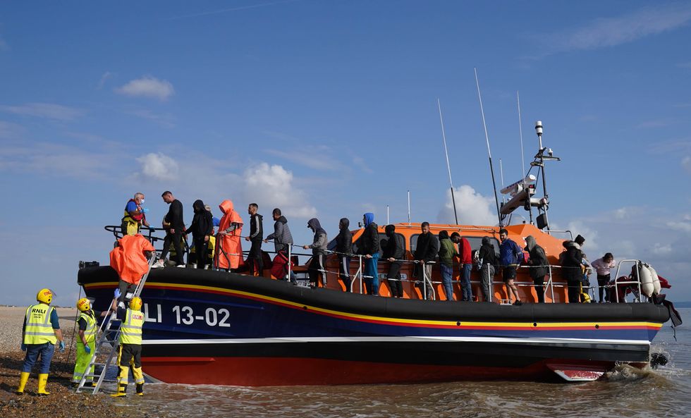 A group of people thought to be migrants are brought in to Dungeness, Kent, onboard an RNLI Lifeboat following a small boat incident in the Channel. Picture date: Saturday August 27, 2022.