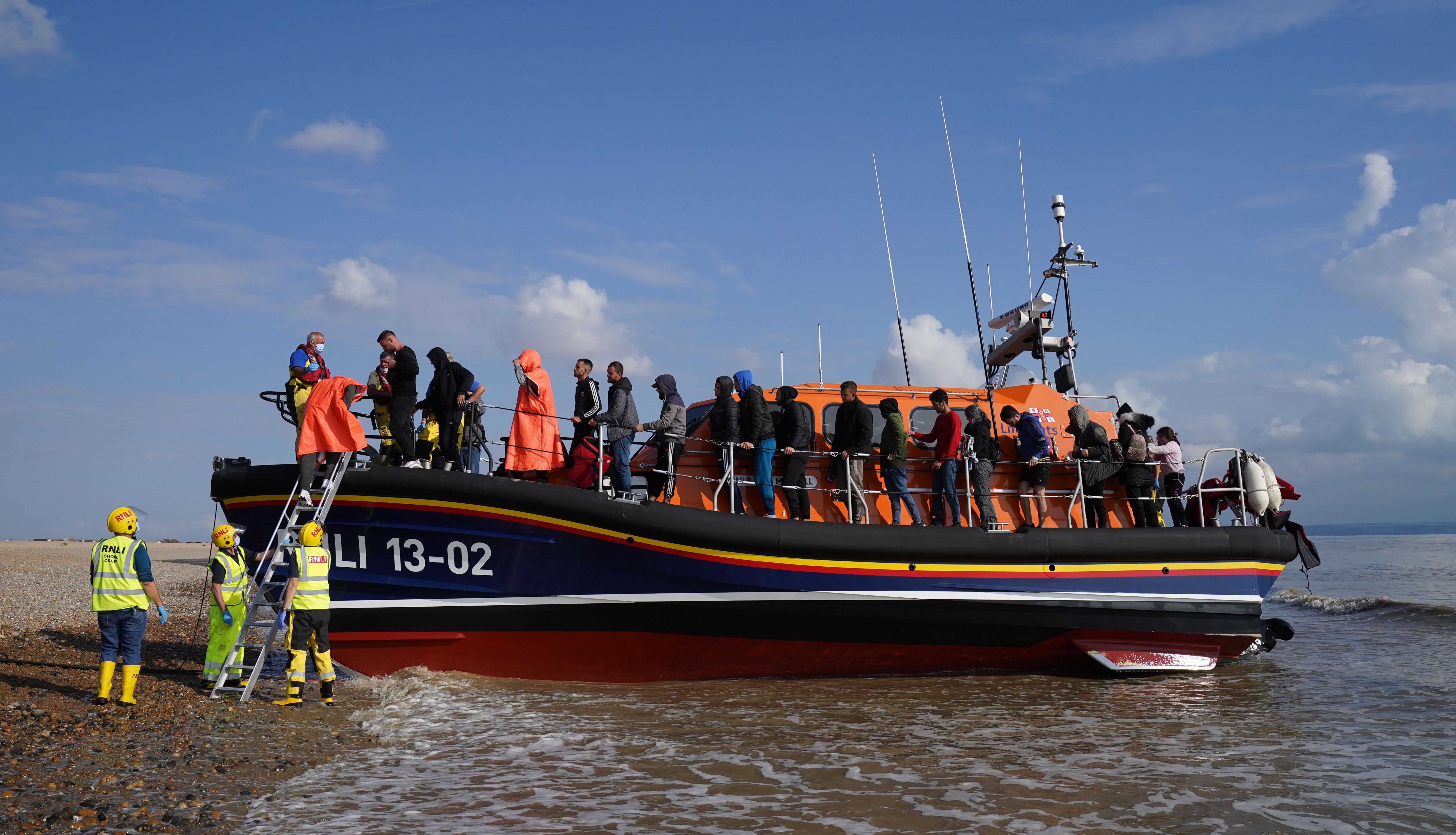A group of people thought to be migrants are brought in to Dungeness, Kent, onboard an RNLI Lifeboat. Many of those crossing the Channel have found to have come from Albania.