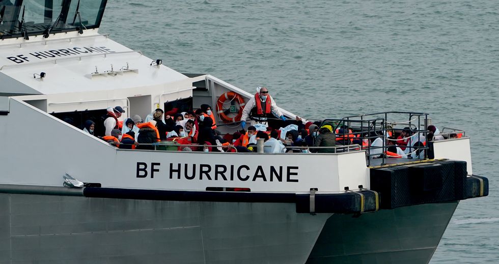 A group of people thought to be migrants are brought in to Ramsgate, Kent, by Border Force officers, following a small boat incident in the Channel. Picture date: Sunday September 26, 2021.
