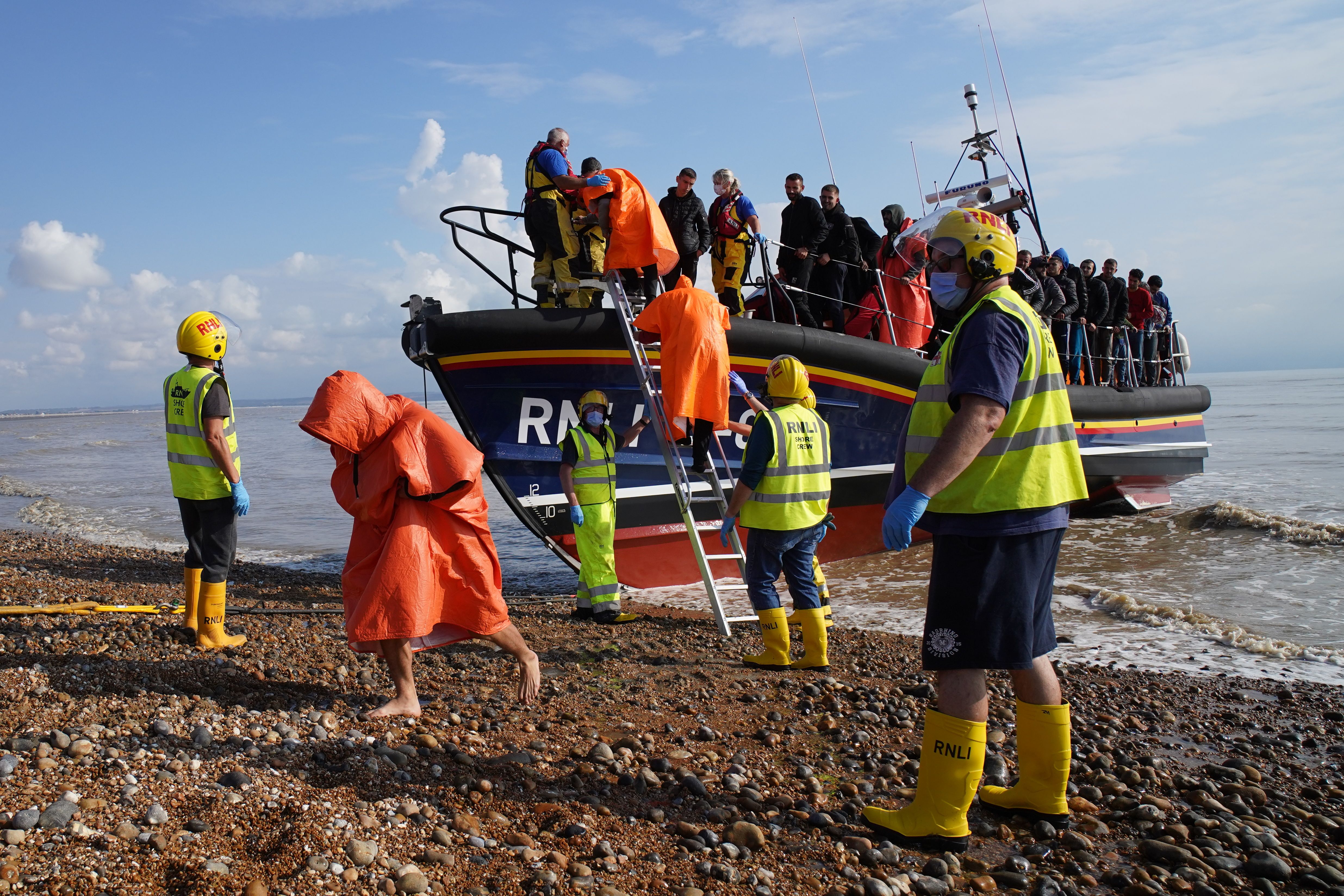 A group of people thought to be migrants are brought into Dungeness, Kent