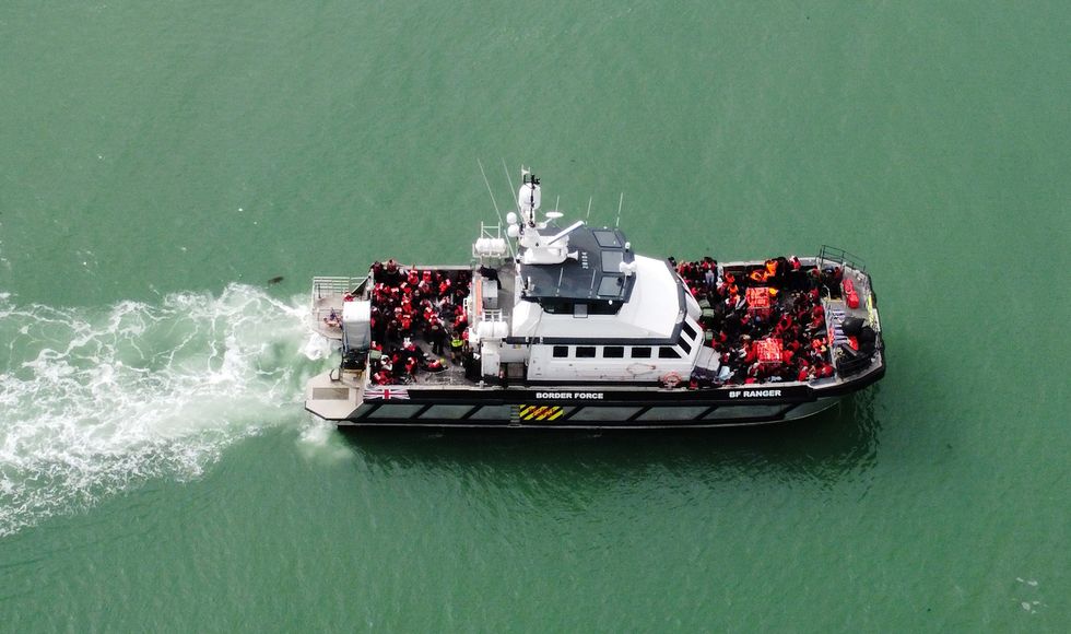 A group of people thought to be migrants are brought into Ramsgate, Kent