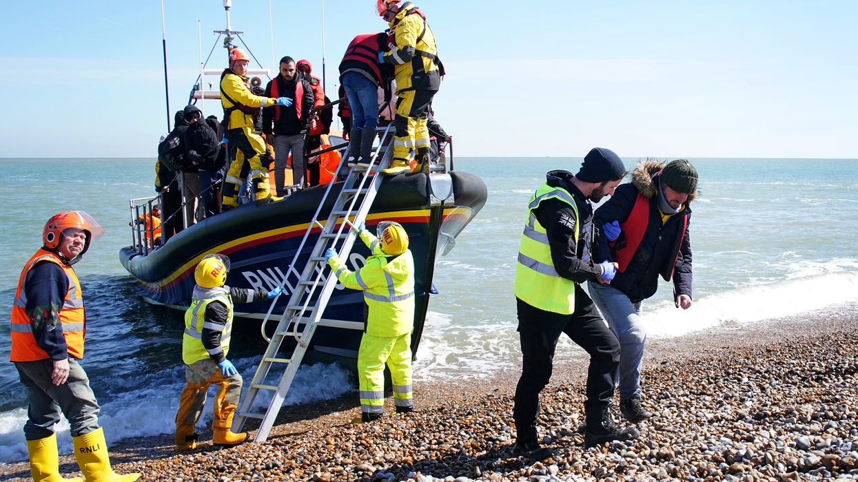 A group of people thought to be migrants arrive on the beach in Dungeness, Kent