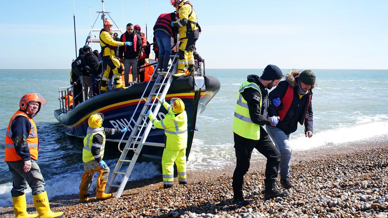 A group of people thought to be migrants arrive on the beach in Dungeness, Kent