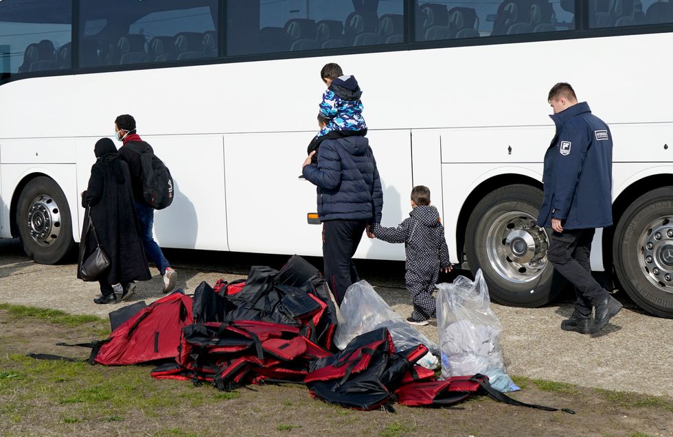 A group of people thought to be migrants board a bus in Dungeness, Kent, after being rescued in the Channel by the RNLI following following a small boat incident. Picture date: Thursday September 22, 2022.
