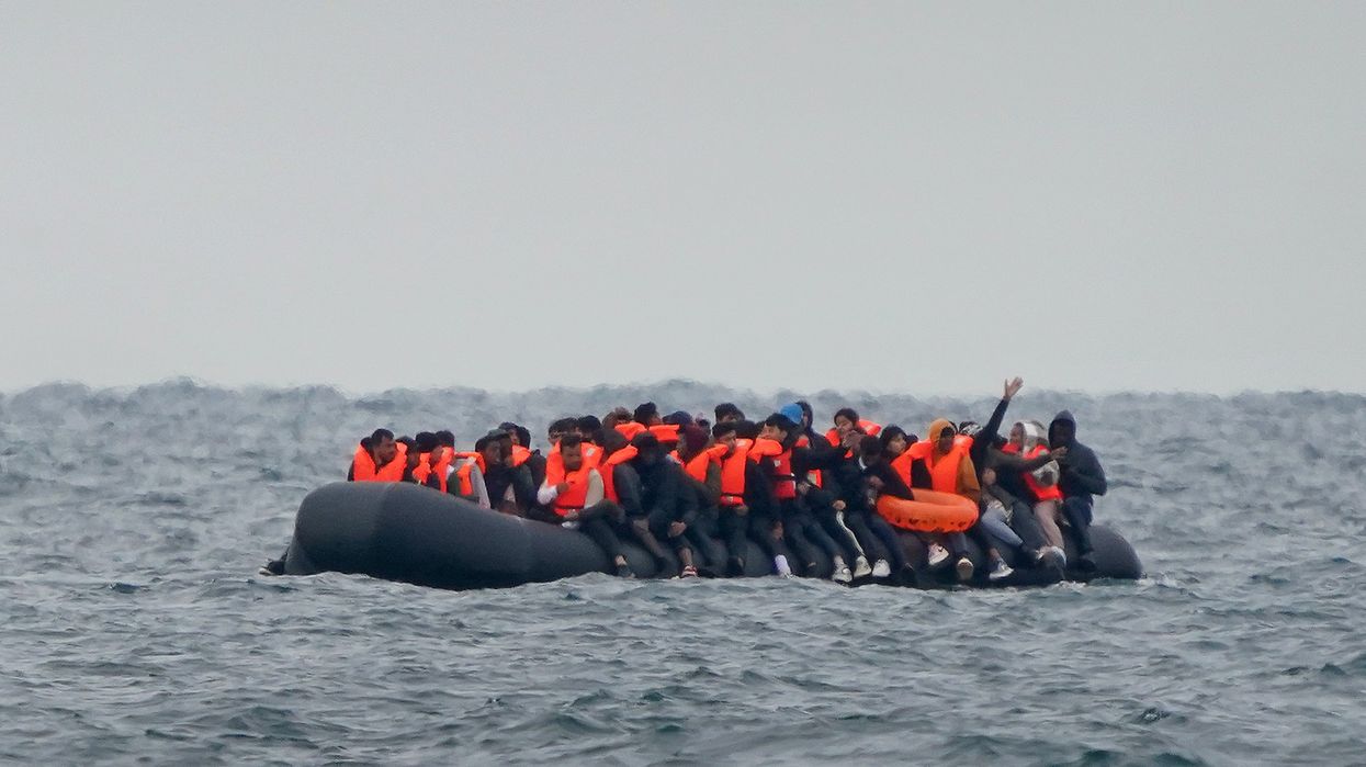 A group of people thought to be migrants crossing the Channel in a small boat traveling from the coast of France and heading in the direction of Dover, Kent