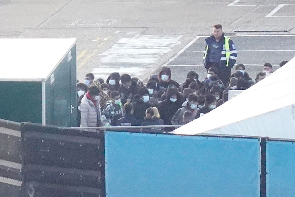 A group of people thought to be migrants wait to be processed at the Border Force compound in Dover, Kent, after being brought from a Border Force vessel following a small boat incident in the Channel. Picture date: Saturday November 12, 2022.