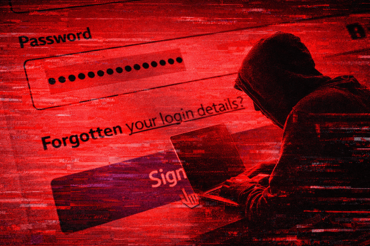 a hacker sits hunched over a laptop with a password login screen shown in the background