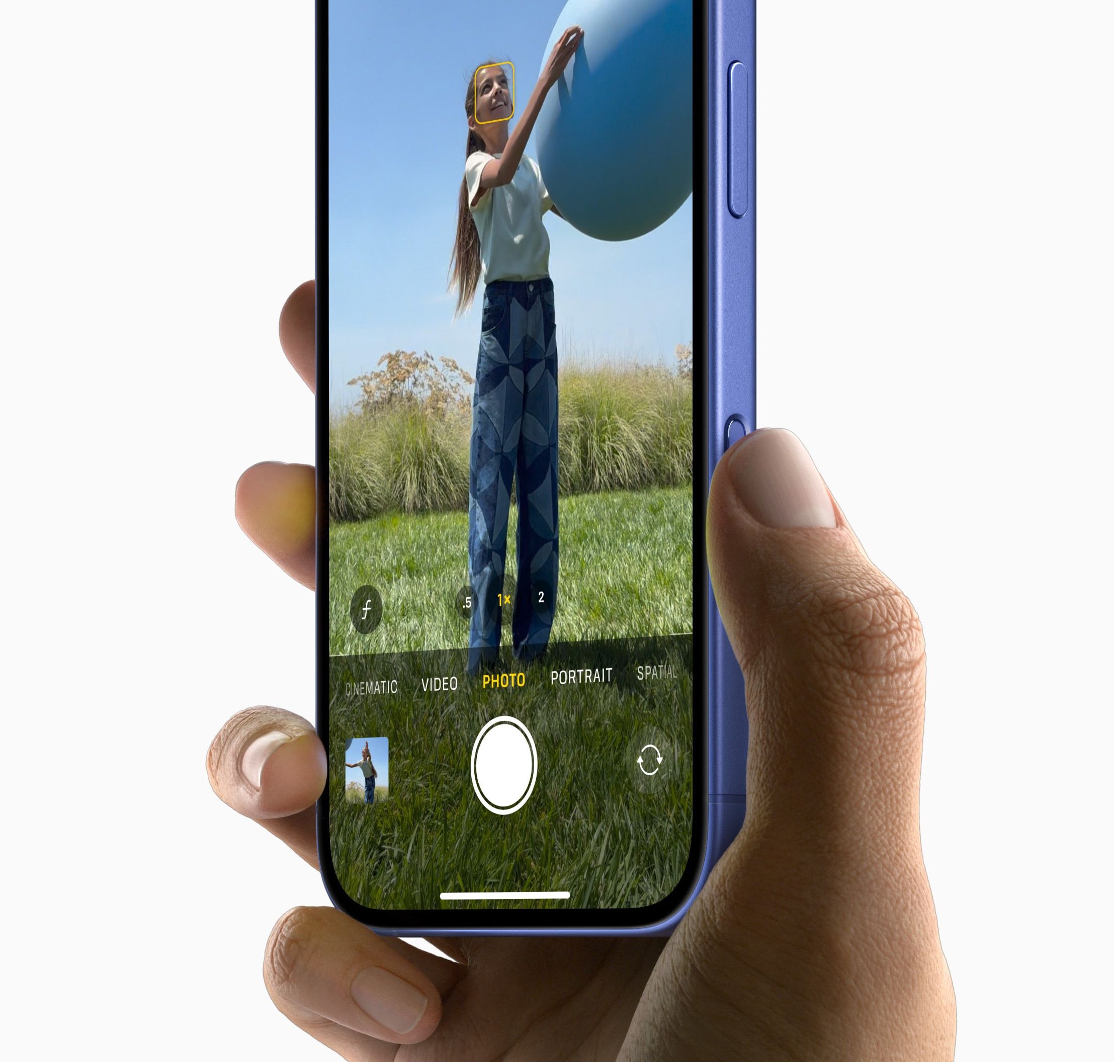 a hand hits the new camera control button on the side of the iPhone 16