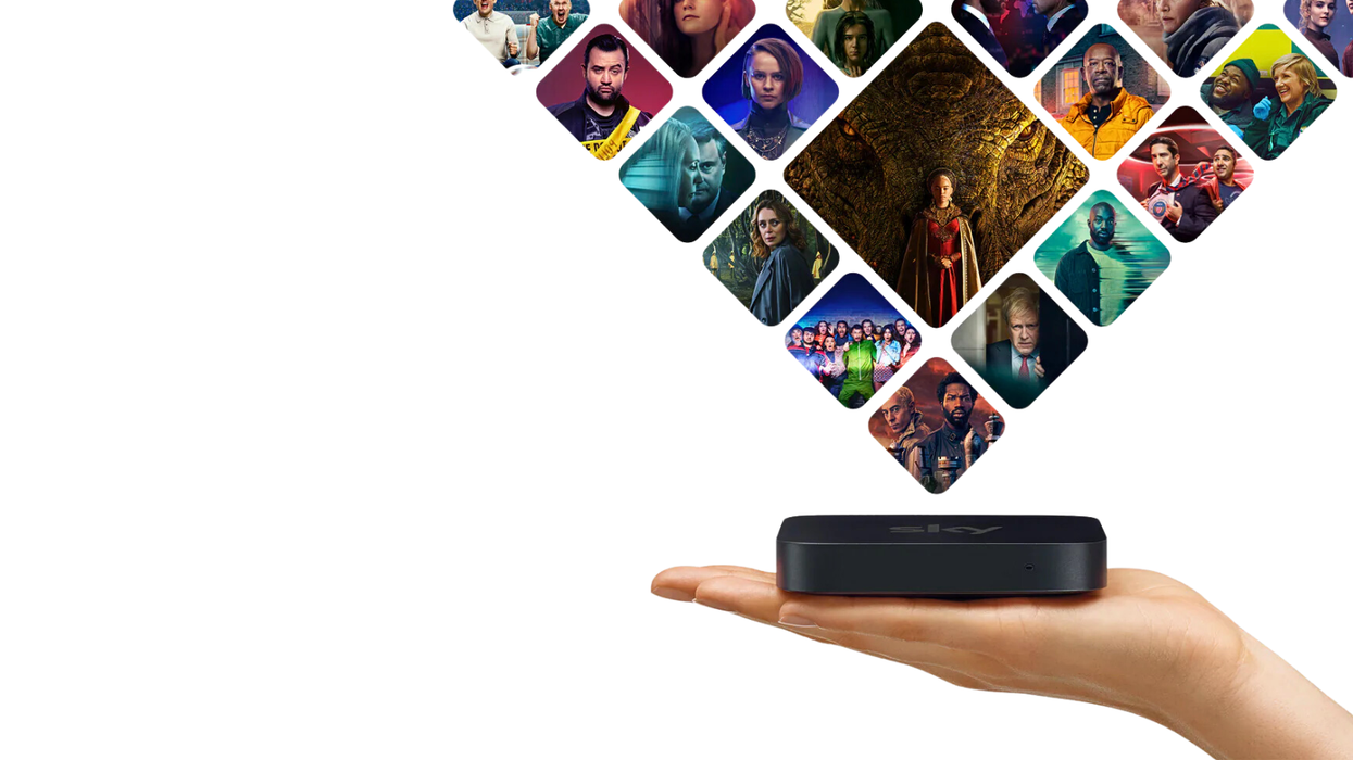 a hand holding the sky stream puck with previews of the biggest sky tv shows above