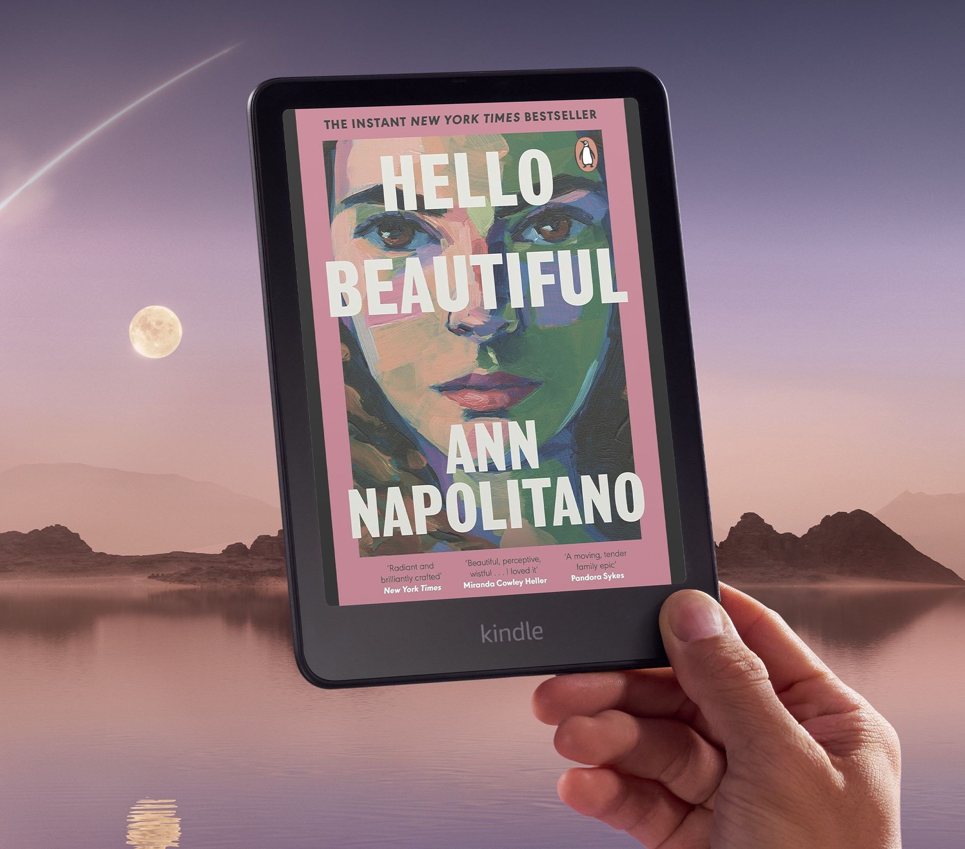 a hand holds a kindle colorsoft with a colourful book cover pictured on-screen