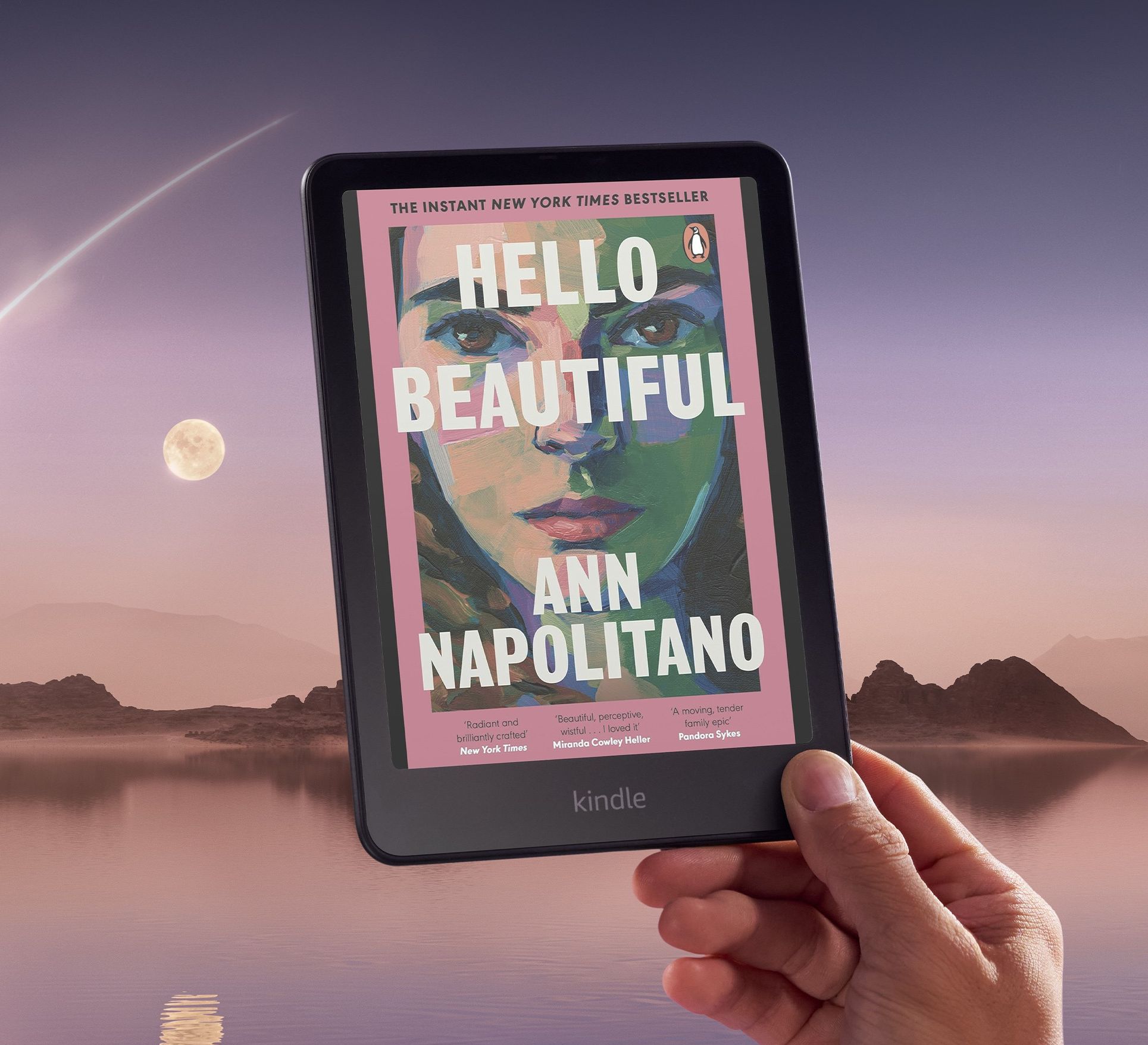 a hand holds a kindle colorsoft with a colourful book cover pictured on-screen
