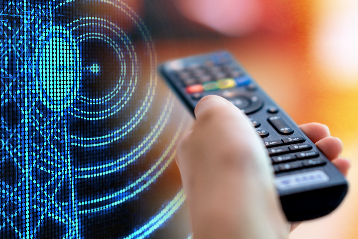 a hand holds a remote control pointed at a television with a digital illustration of a TV mast in the background 