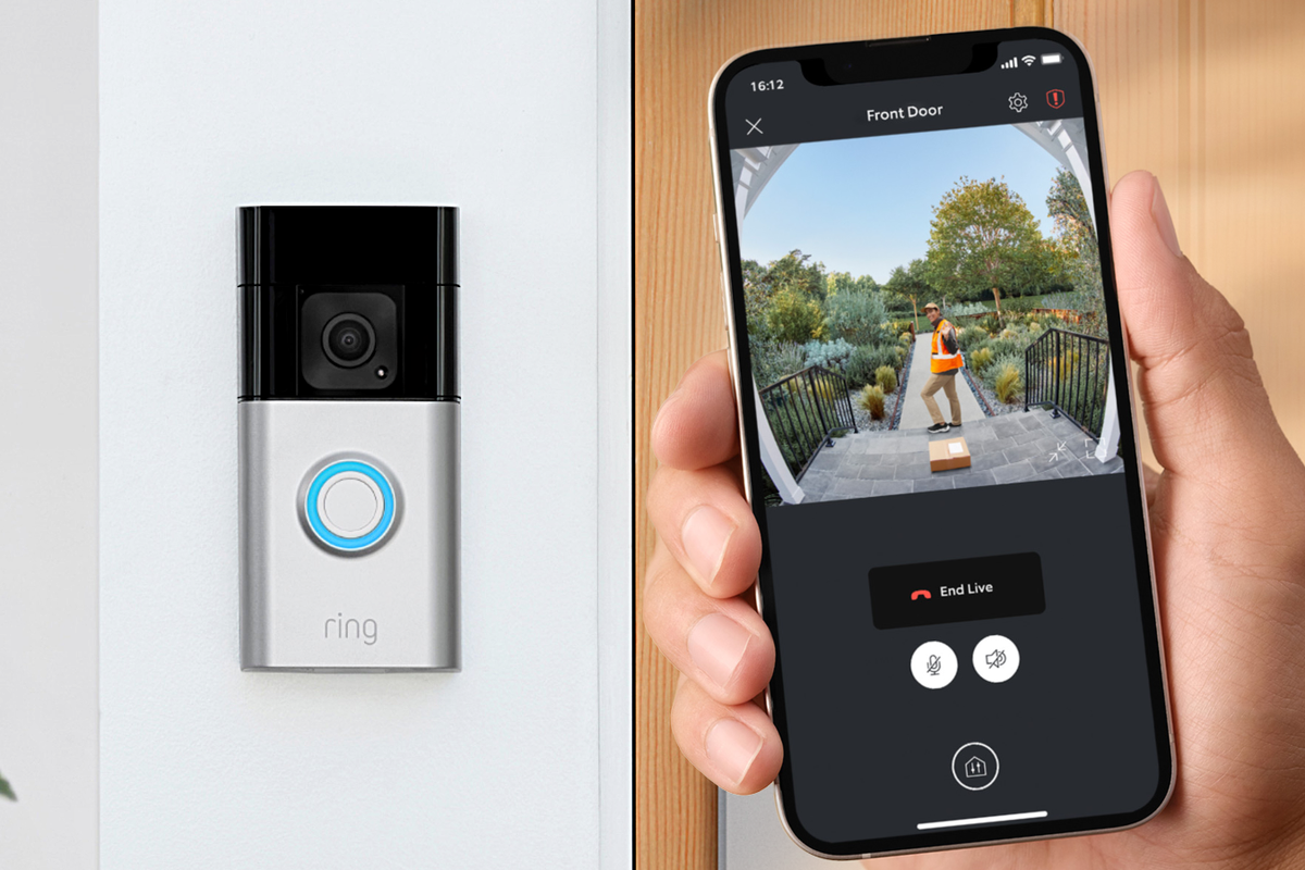 a hand holds a smartphone with a live view from a ring doorbell with the doorbell pictured in place in the background