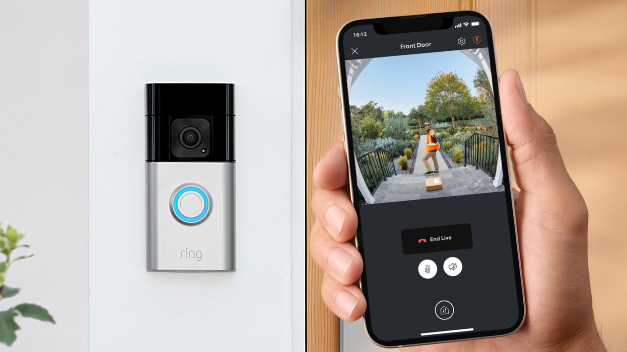 a hand holds a smartphone with a live view from a ring doorbell with the doorbell pictured in place in the background