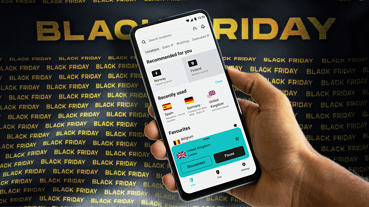 a hand holds a smartphone with the black friday banner in the background