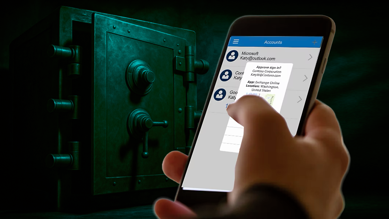 a hand holds an iphone with microsoft authenticator running on-screen with a safe in the background broken open