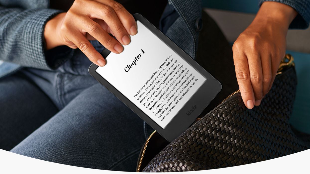 a hand holds the amazon kindle and puts the device into a bag