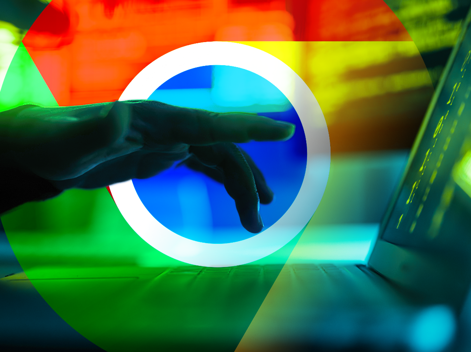 a hand hovers after typing on a laptop with the google chrome web browser logo in the background