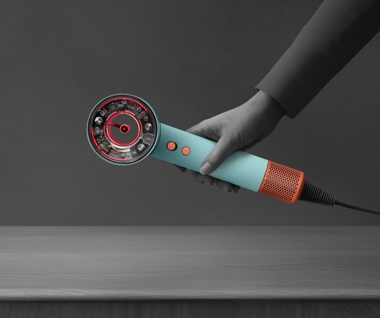 a hand picks up the dyson nural from a table while the led indicator light flashes red
