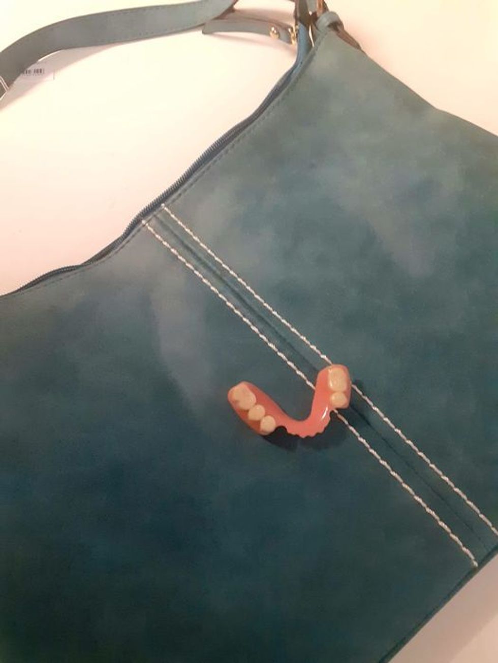 A handbag with a set of false teeth inside that was handed into Barnardo's in Glasgow, one of the strangest items left by contributors at its stores.