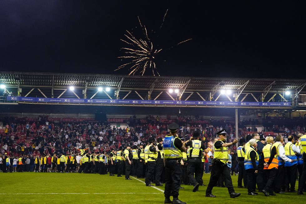A heavy police presence was seen on the pitch after fans took to the pitch.