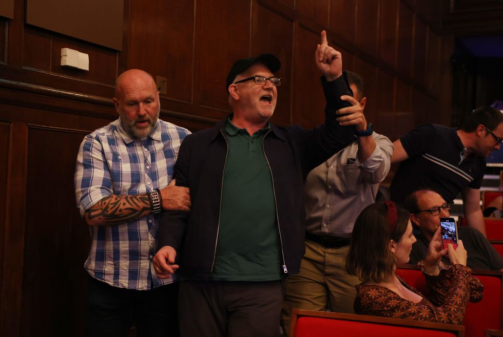 A heckler is removed by security during a Reform UK press conference presenting their programme for the upcoming Parliament,