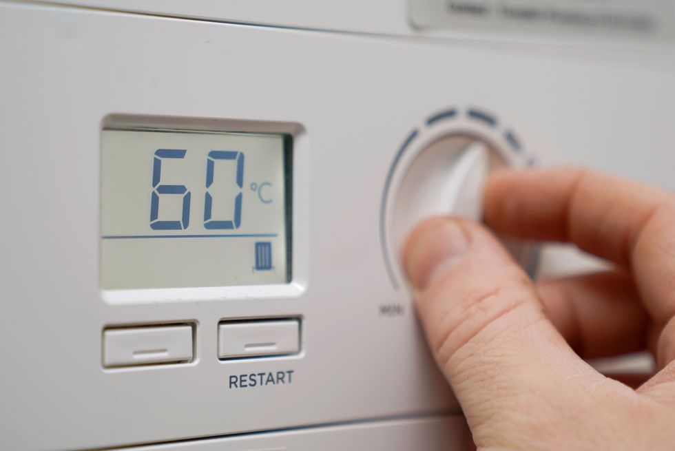 A homeowner turns down the temperature of a gas boiler in Basingstoke, Hampshire. Ofgem is expected to announce that the energy price cap is to rise by 50 percent because of soaring wholesale gas prices, meaning the average bill could hit 1,915. Picture date: Thursday February 3, 2022.