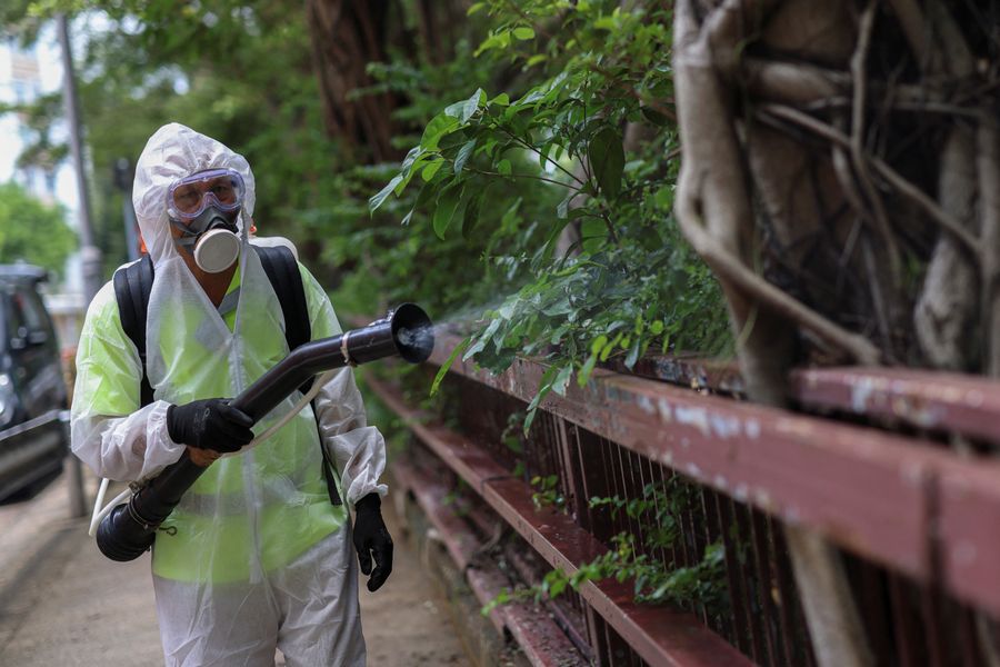 A Hong Kong official sprays down a public park amid the chikungunya outbreak