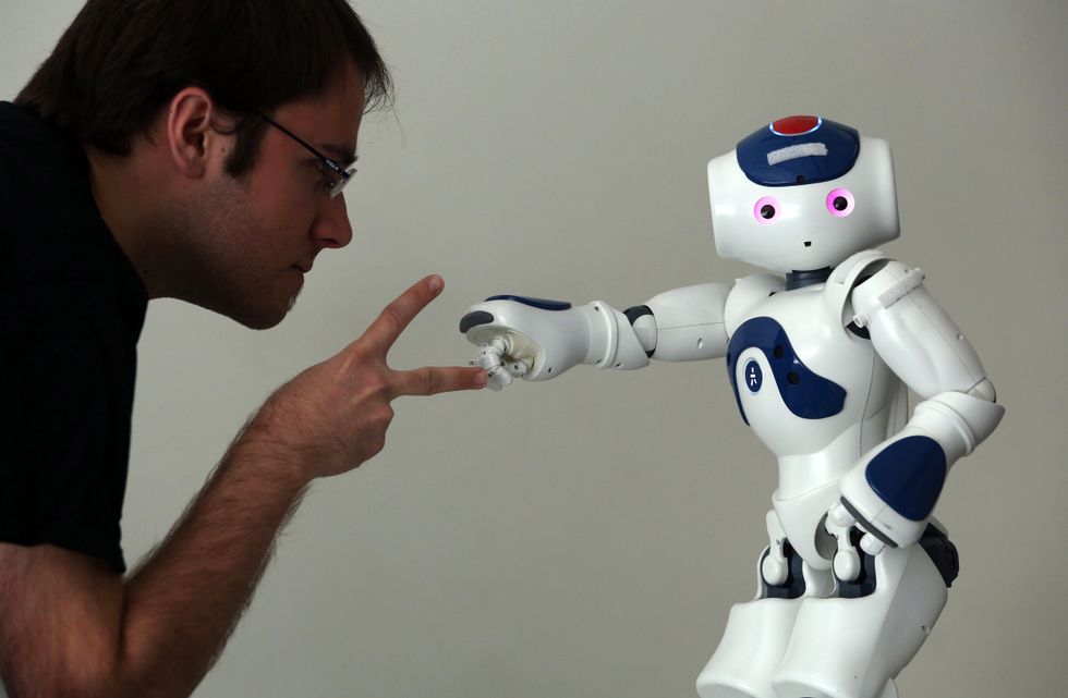 A human interacts with a robot