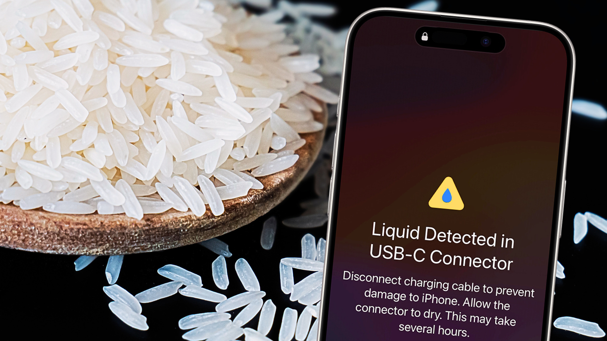 a iphone is pictured with a warning about liquid in the charging port with rice scattered in the background