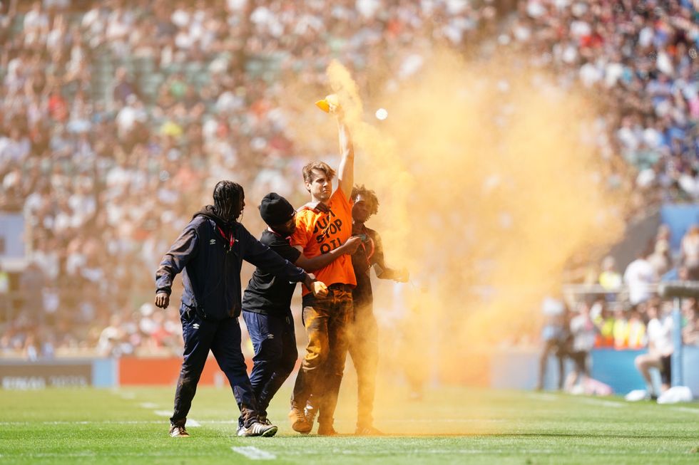 A Just Stop Oil protester invades the Twickenham field