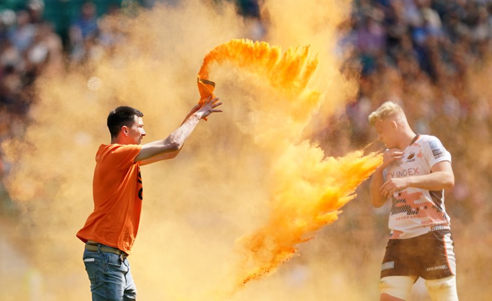 A Just Stop Oil protester invades the Twickenham field