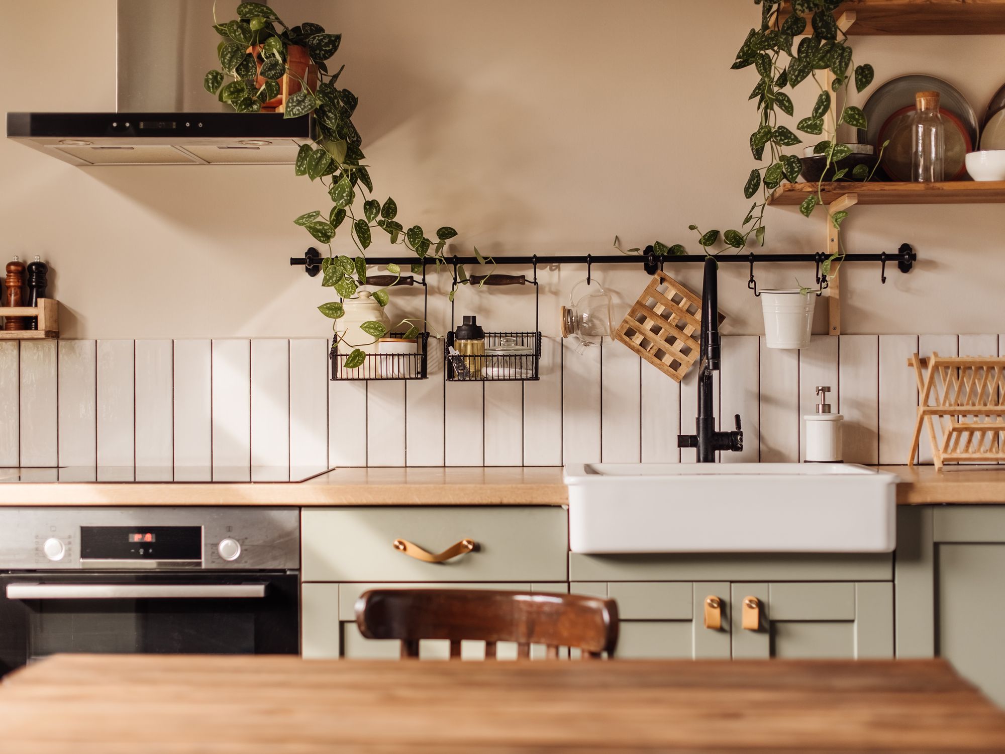 A kitchen with light green cabinets