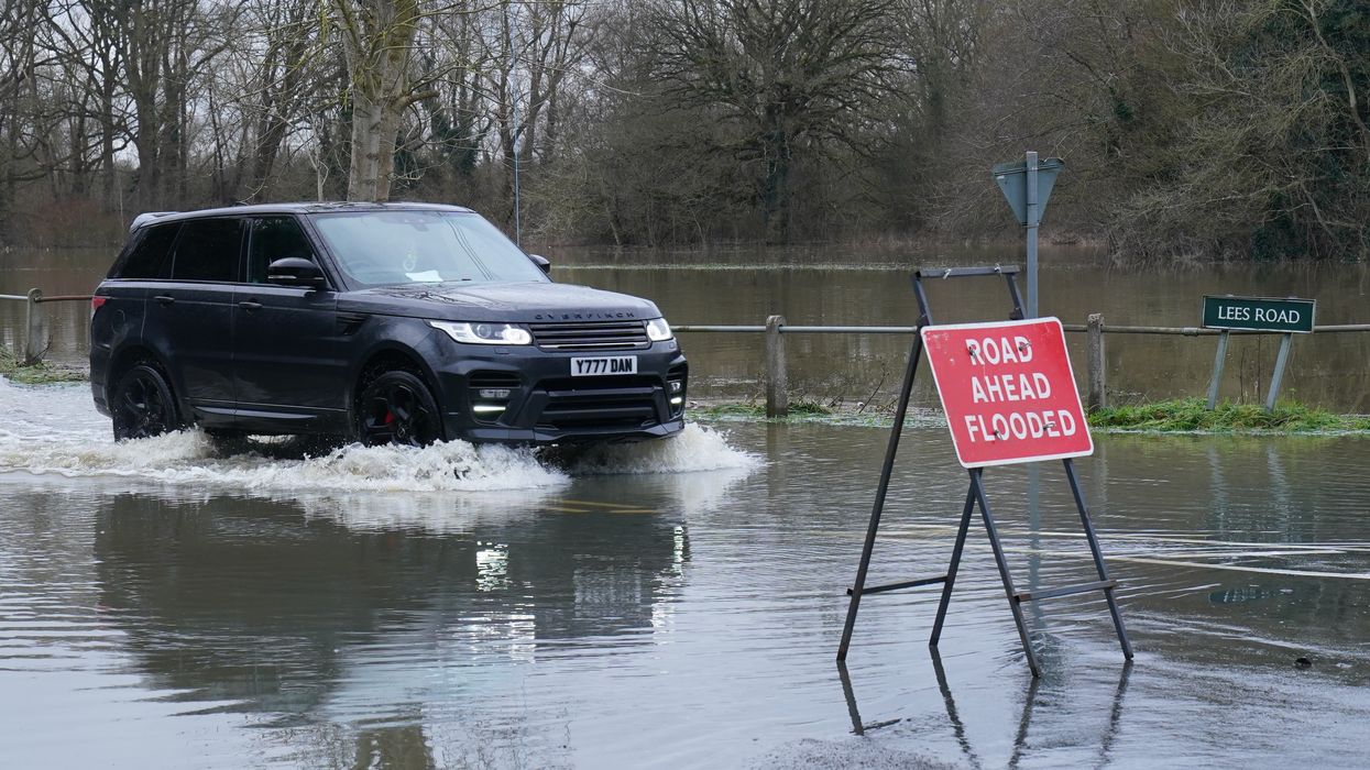 A Land Rover driving through floodwater