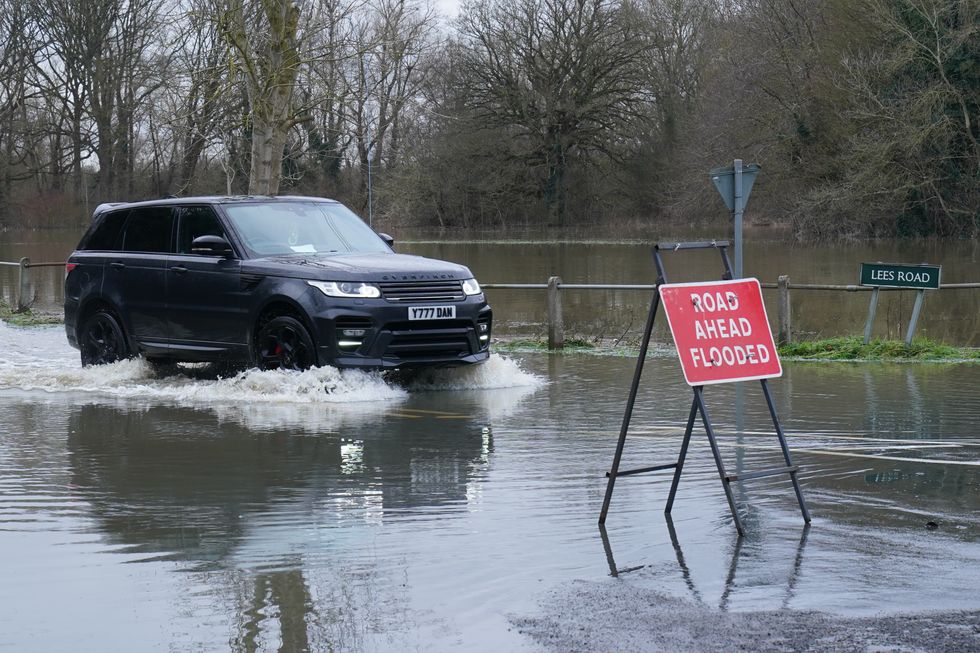 A Land Rover driving through floodwater