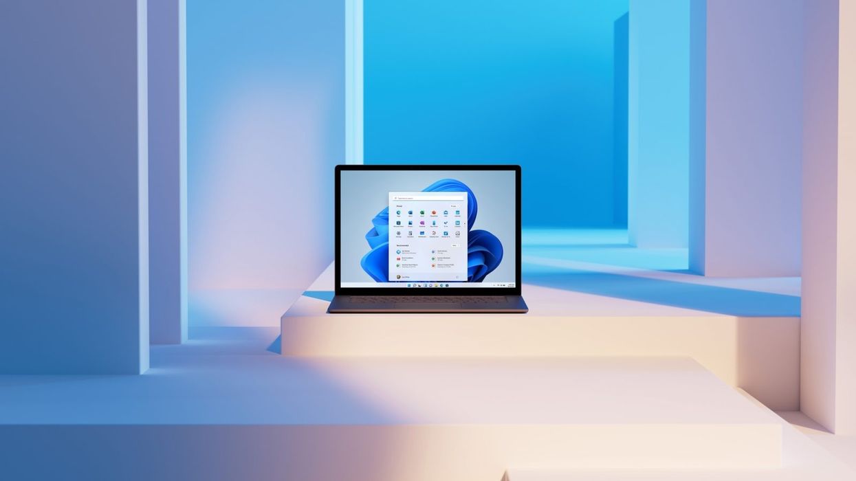 a laptop running windows 11 is pictured on a series of colourful ledges