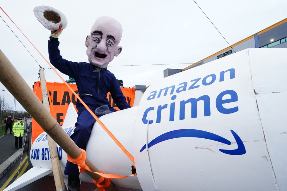 A large figure depicting Jeff Bezos outside the distribution centre.