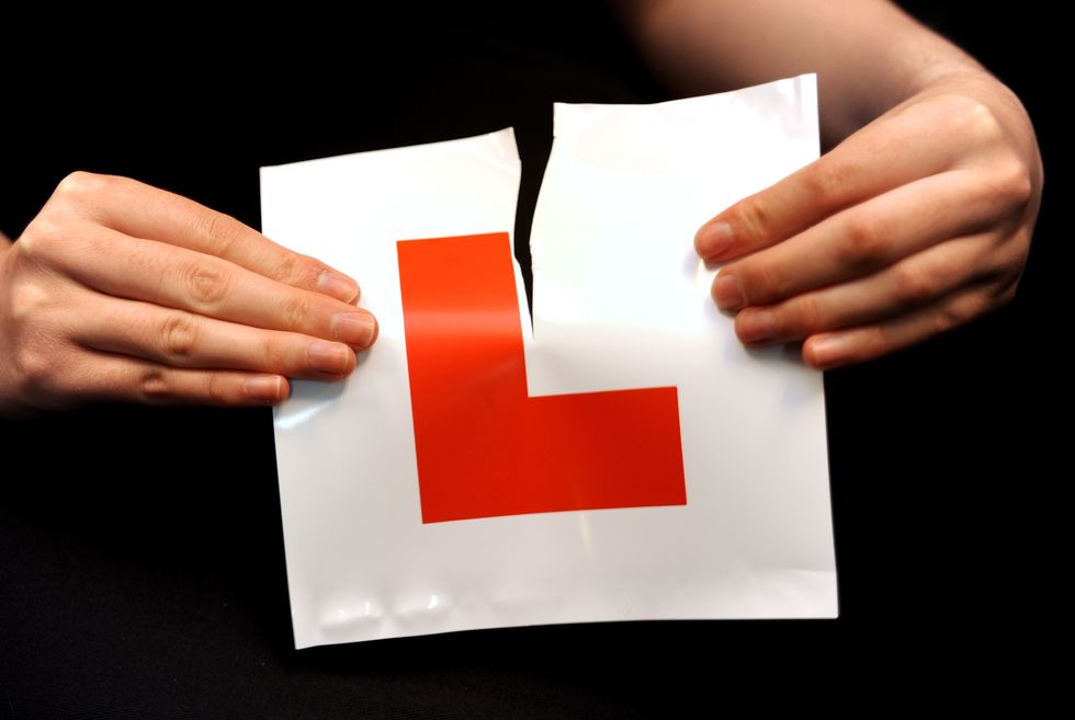 A learner driver ripping up her L plate